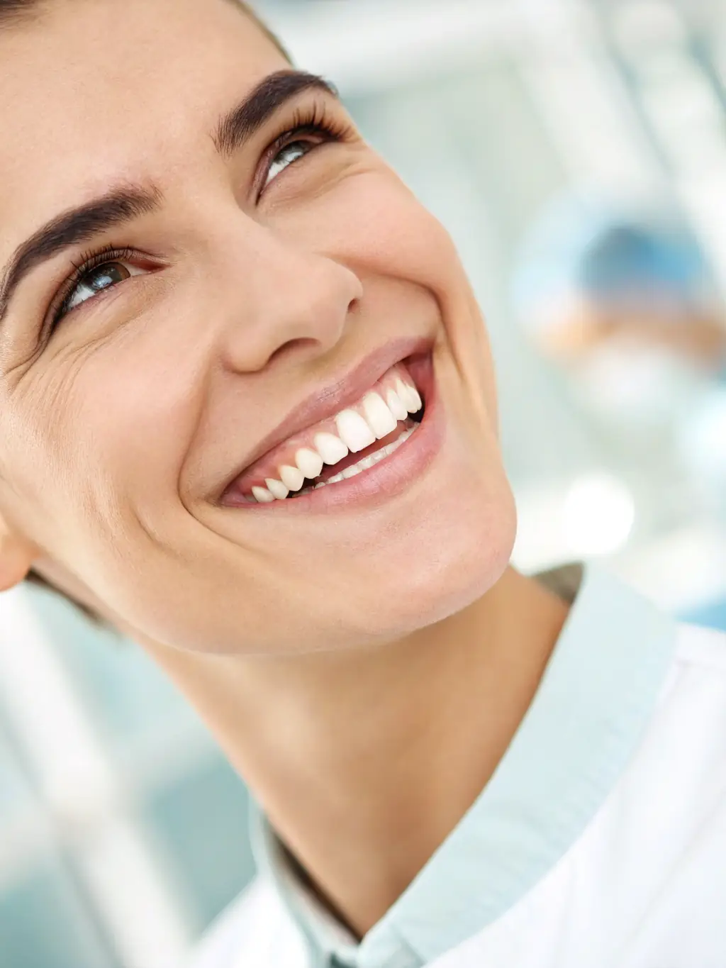 A close-up shot of a patient's smile before and after a teeth whitening treatment at White Pearl Dental Practice, highlighting the dramatic results.